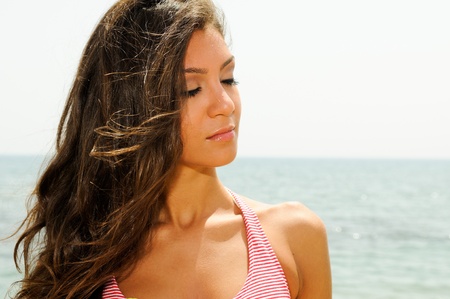Portrait of a beautiful woman with long pink dress on a tropical beach の写真素材