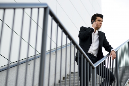 Portrait of a young businessman in an office building talking on the phoneの写真素材