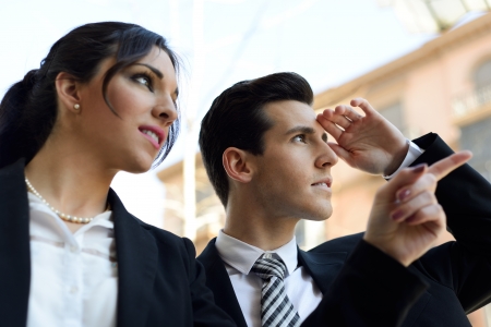 Portrait of attractive businessman and businesswoman looking at something interesting  Couple working の写真素材