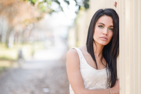 Portrait of brunette young woman with green eyes, wearing casual clothes, in urban backgroundの写真素材