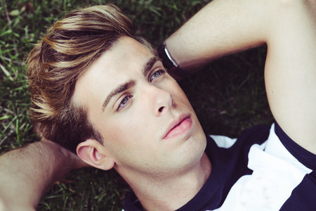 Portrait of a young handsome man, model of fashion, with modern hairstyle in urban background  Blonde hairの写真素材