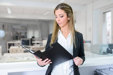 Portrait of business woman in modern glass interior 