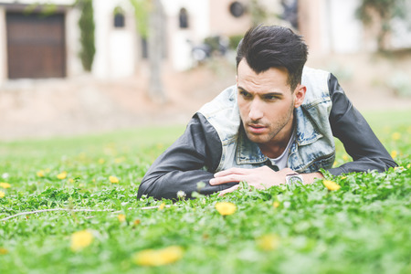 Portrait of a young handsome man, model of fashion, with modern hairstyle in urban backgroundの写真素材