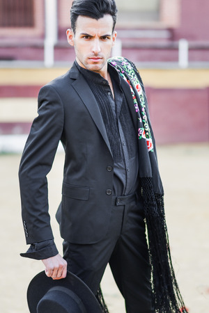 Portrait of a handsome man, model of fashion, wearing spanish clothes in a bullringの写真素材