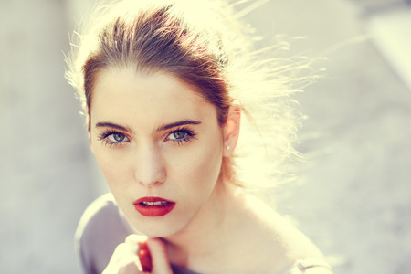 Close up portrait of beautiful blonde girl in urban backgroundの写真素材