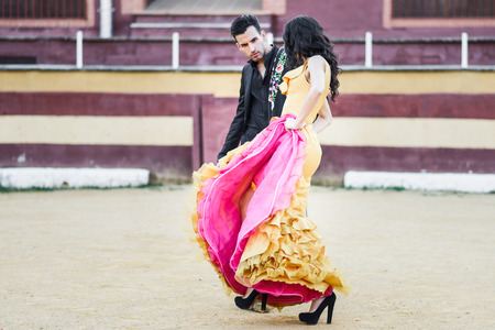 Portrait of a pretty couple, models of fashion, in a bullring. Spanish styleの写真素材