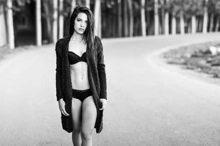 Portrait of woman in lingerie walking in a rural roadの写真素材