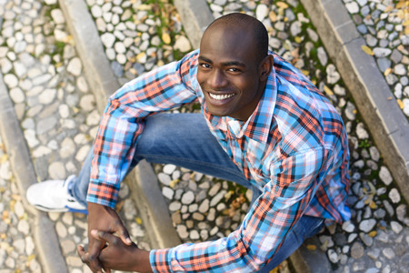 Portrait of black man very happy, smiling in urban backgroundの写真素材
