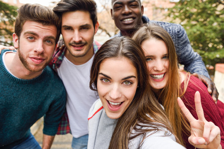 Group of multi-ethnic young people having fun together outdoors