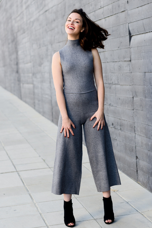 Beautiful young woman, model of fashion, smiling in urban backgroundの写真素材