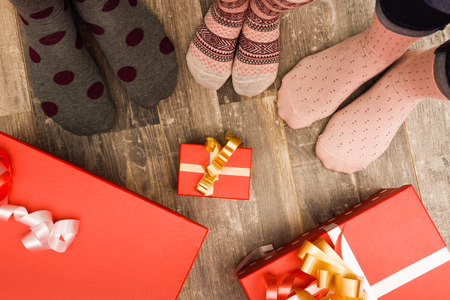 Feet of three people family on wood floor. Christmas holidays conceptの写真素材