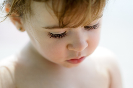 Close-up potrait of adorable little girl outdoors.の写真素材
