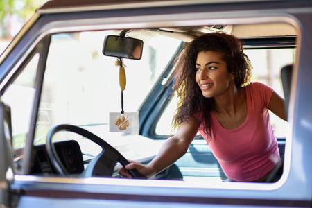 Arab woman inside an old van parked in a campsite in the middle of natureの写真素材