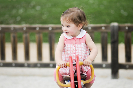 Little girl playing in a urban parkの写真素材