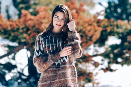 Young woman enjoying the snowy mountains in winterの写真素材