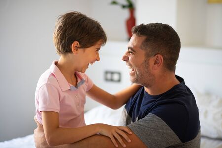 Middle-age man and her little daughter are hugging.