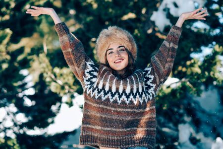 Young woman enjoying the snowy mountains in winterの写真素材