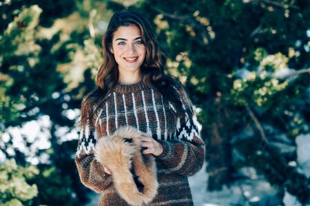Young woman enjoying the snowy mountains in winter
