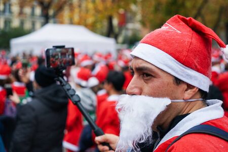 Madrid, Spain, December 8th 2019: Crowd of Santa Clauses running in streetのeditorial素材