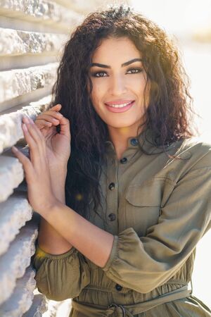 Young Arab Woman with curly hair outdoors