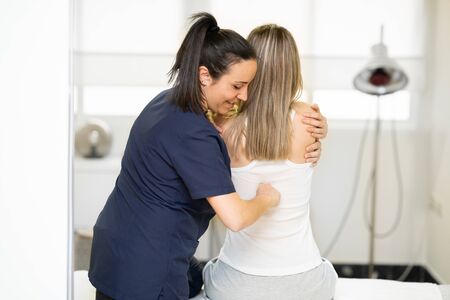 Physiotherapist inspecting her patient in a physiotherapy center.