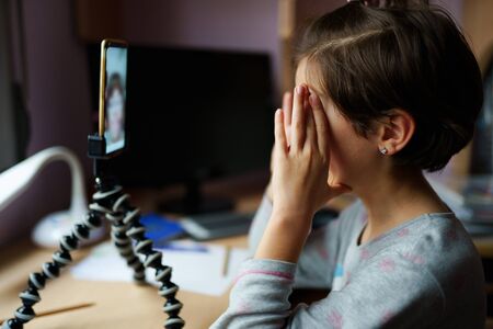 Little girls talking via video conference with smartphone