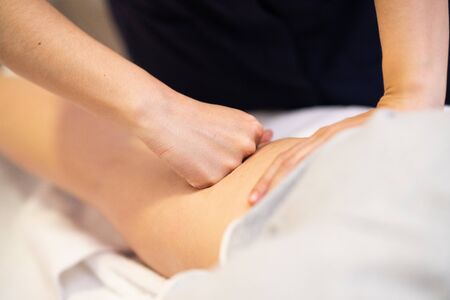 Medical massage at the leg in a physiotherapy center.の写真素材