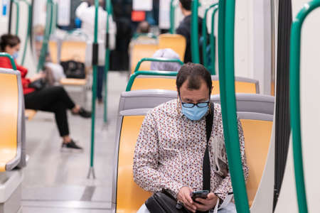 People wearing surgical mask in the train during the Covid-19 pandemicのeditorial素材