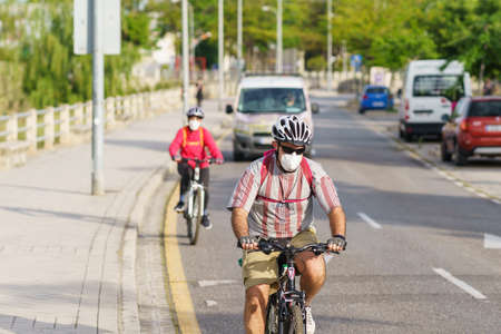 People riding bikes, wearing masks, as protection from the Covid-19 pandemicのeditorial素材