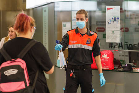 Civil protection man handing out masks to protect against Covid-19