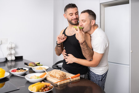 Gay couple cooking healthy vegan food together at home.の写真素材