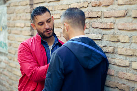 Gay couple in a romantic moment on the street.の写真素材