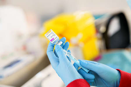 GRANADA, ANDALUSIA, SPAIN. FEBRUARY 26TH, 2021. Mass vaccination against Covid-19, using Astrazenecas vaccine. Nurse loading syringe with vaccine.のeditorial素材
