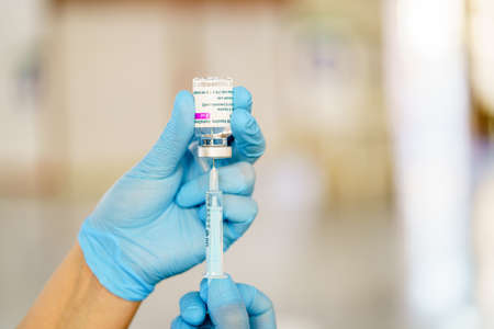 GRANADA, ANDALUSIA, SPAIN. FEBRUARY 26TH, 2021. Mass vaccination against Covid-19, using Astrazenecas vaccine. Nurse loading syringe with vaccine.のeditorial素材