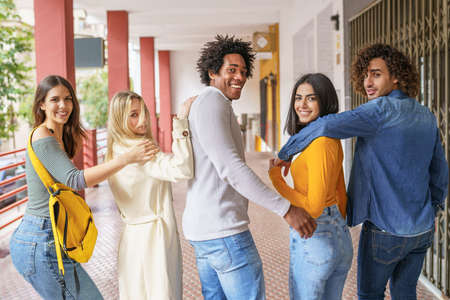 Multi-ethnic group of friends walking together on the street.