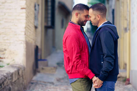 Gay couple in a romantic moment in the street.の写真素材