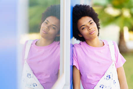African American woman in casual clothes looking at the camera. Happy young female in urban background.の写真素材