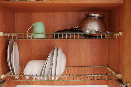 Practically arranged kitchen items with inviting natural light, Minimalist culinary storage...