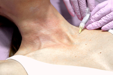 Closeup neck receiving cosmetic injection gloved hands holding microcannula over decolletage bright...