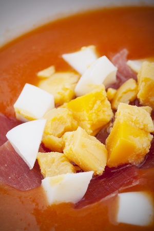 Spanish gazpacho with ham and boilded egg in close-up photoの写真素材