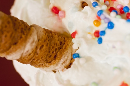 close-up image of a wafer biscuit on  cream and candiesの写真素材