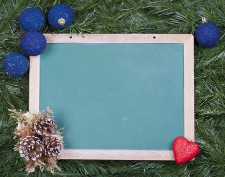 Blackboard with assorted and colorful christmas ornatesの写真素材
