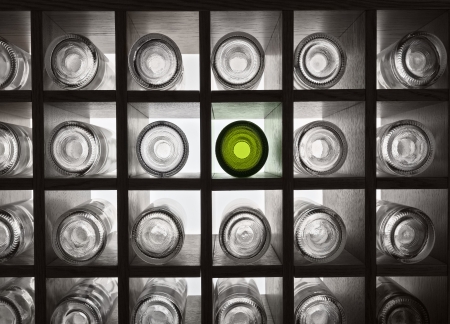 Empty wine bottles on shelves with backlightの写真素材