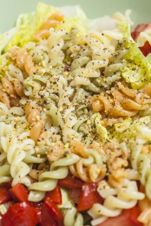 Colorful salad with pasta and variety of vegetables.の写真素材