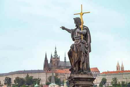 St  John the Baptist, is shown as a preacher with a golden cross and a font from a shell on his side   Sculpted by Josef Max in 1857 in the Charles Bridge, Prague, Czech Republicの写真素材