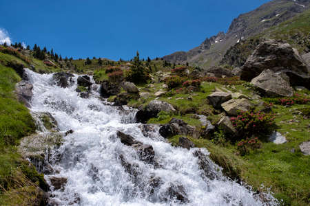 high mountain landscape with a rushing river in the pyreneesの写真素材