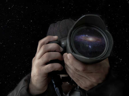 photographer taking a night shot of the stars with the lens and hands in the foreground