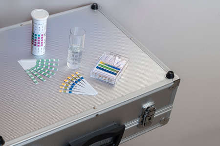 metal case with equipment for water analysis, ph and total water hardness test strips with a...
