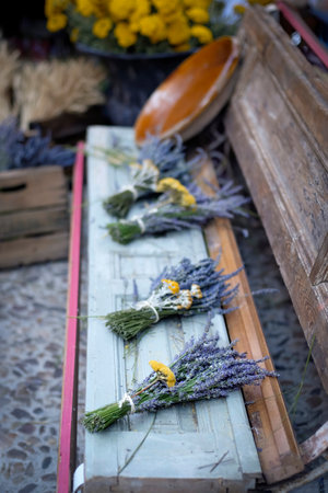 bouquets of lavender flowers on an antique wooden bench at a street market, lavender festival of Brihuega, Guadalajara, Spain, selective focusの写真素材