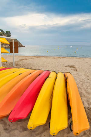 a kayak, canoe and nautical equipment rental establishment, with yellow, orange and red kayaks on...